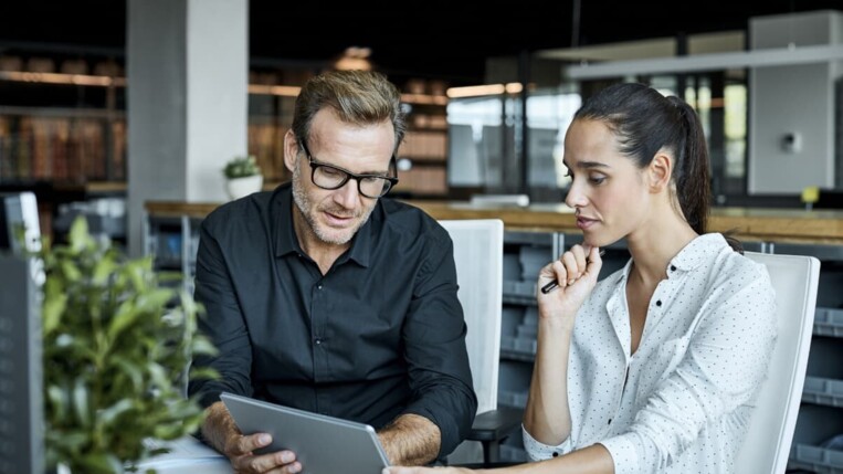 colleagues looking together on a tablet