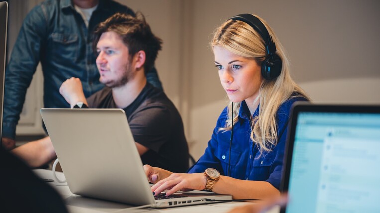 Woman designing a call to action on a laptop