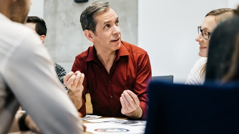 Man talking to his colleagues